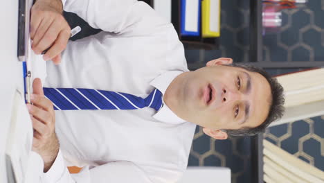 Vertical-video-of-Sick-businessman-sneezing.